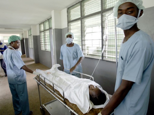 Des infirmiers déplacent un patient dans l'hôpital de Nkwanta, au Ghana, le 6 juin 2005
